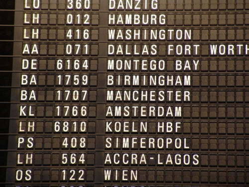vintage time table of flight numbers and destinations at an airport